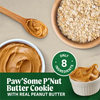 Oven Baked Paw’some Peanut Butter circular dog treats with a tan background that says “Oven baked hand crafted in small batches with a delicious oven baked smell &amp; taste.” 